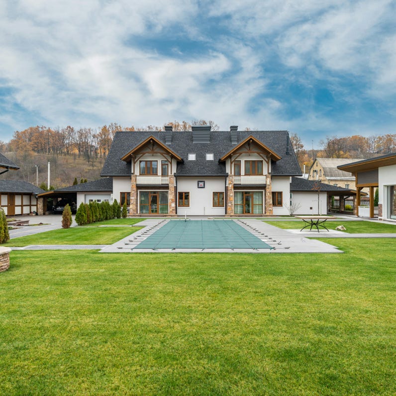 A syringe and dental aligner float above a hand in a modern office, signifying advanced dental care technology.