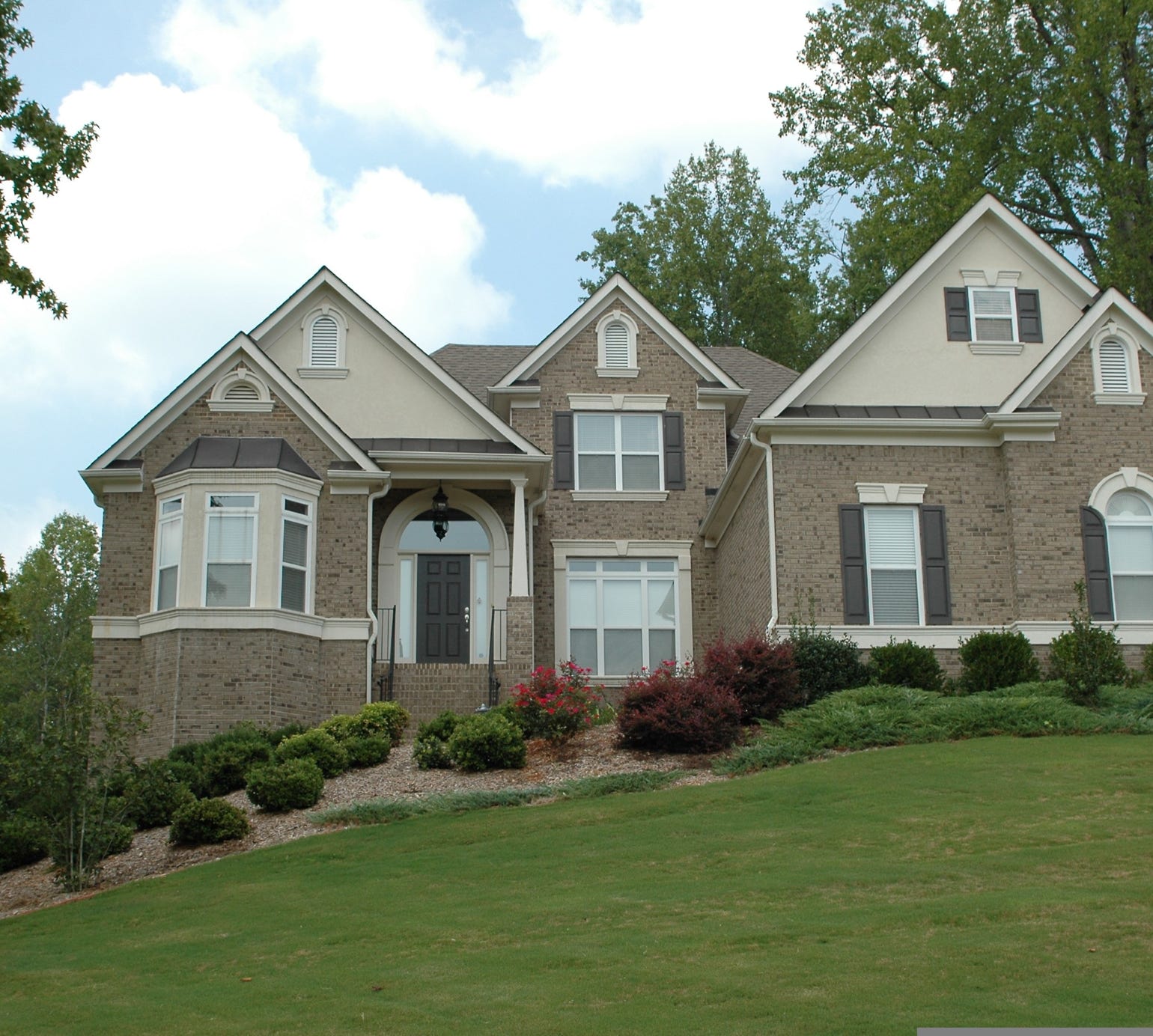 Two adults engaged in a therapy session, seated at a glass table with notebooks and water glasses.